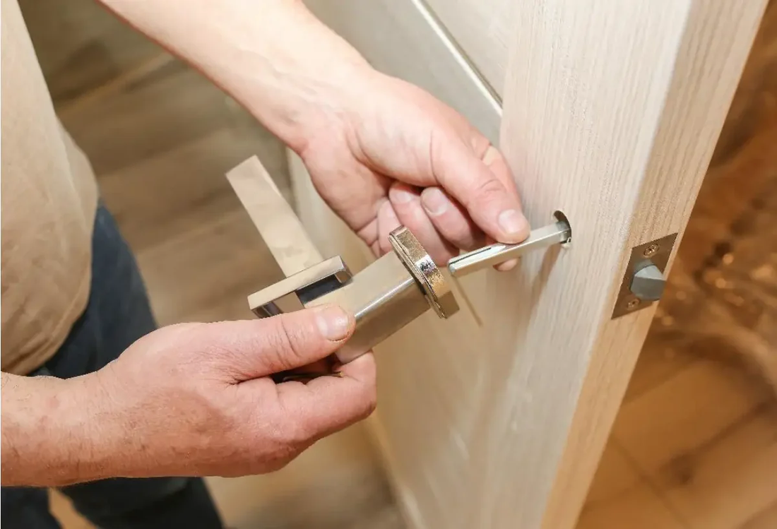 Person removing a new bedroom door handle